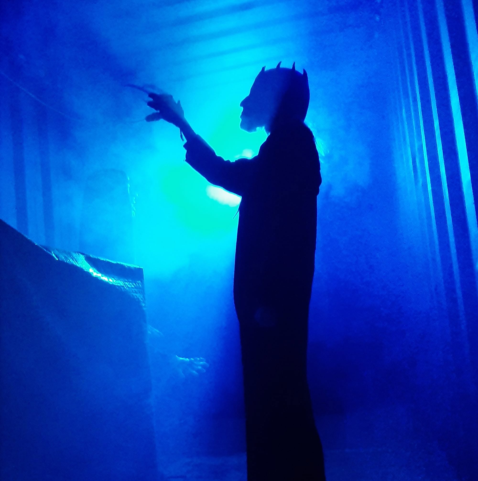 Haunted Forest character silhouetted in eerie blue fog