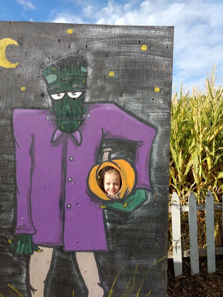 Child posing in a playful Halloween photo board